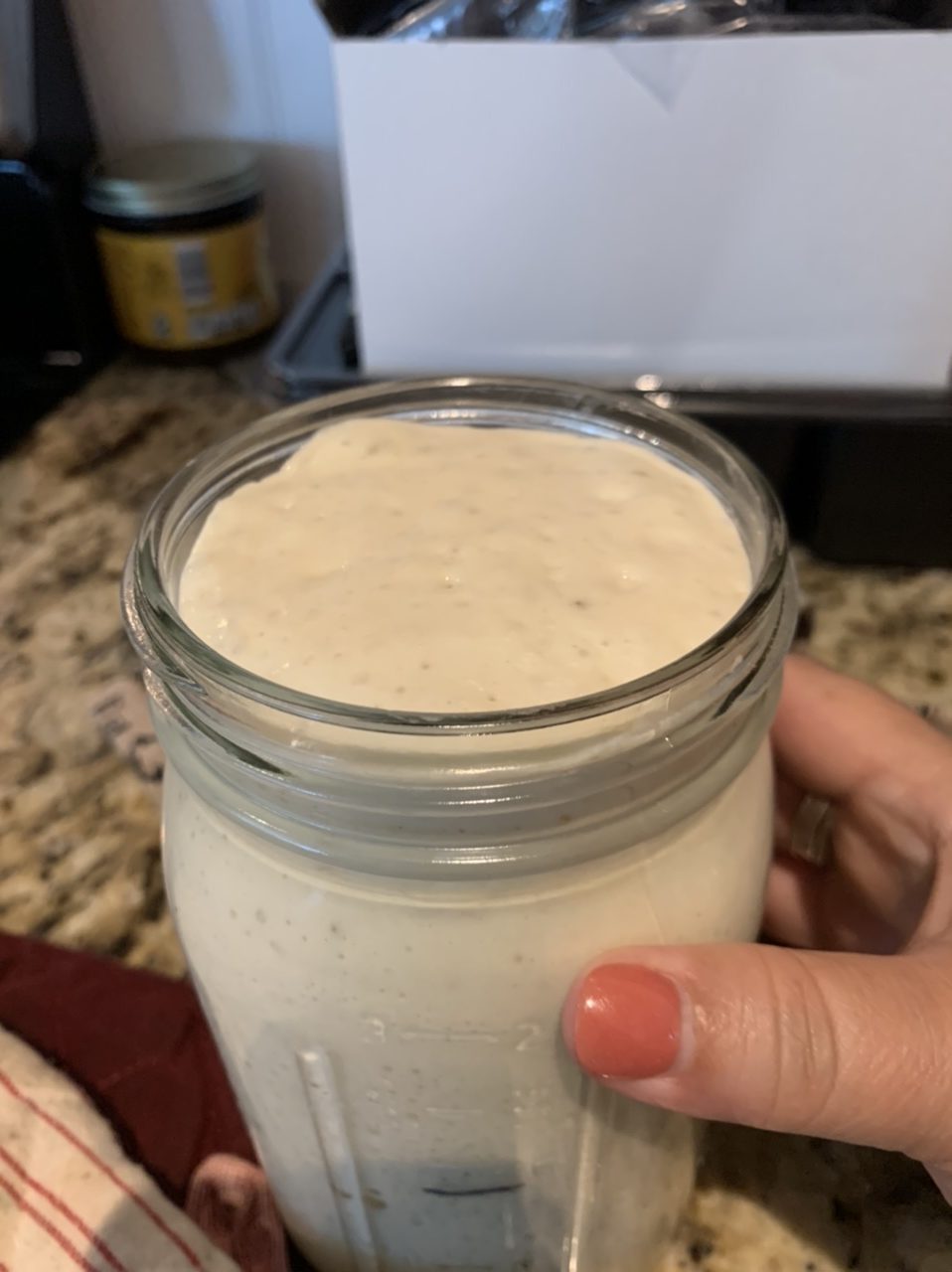 bubbly sourdough starter in glass jar